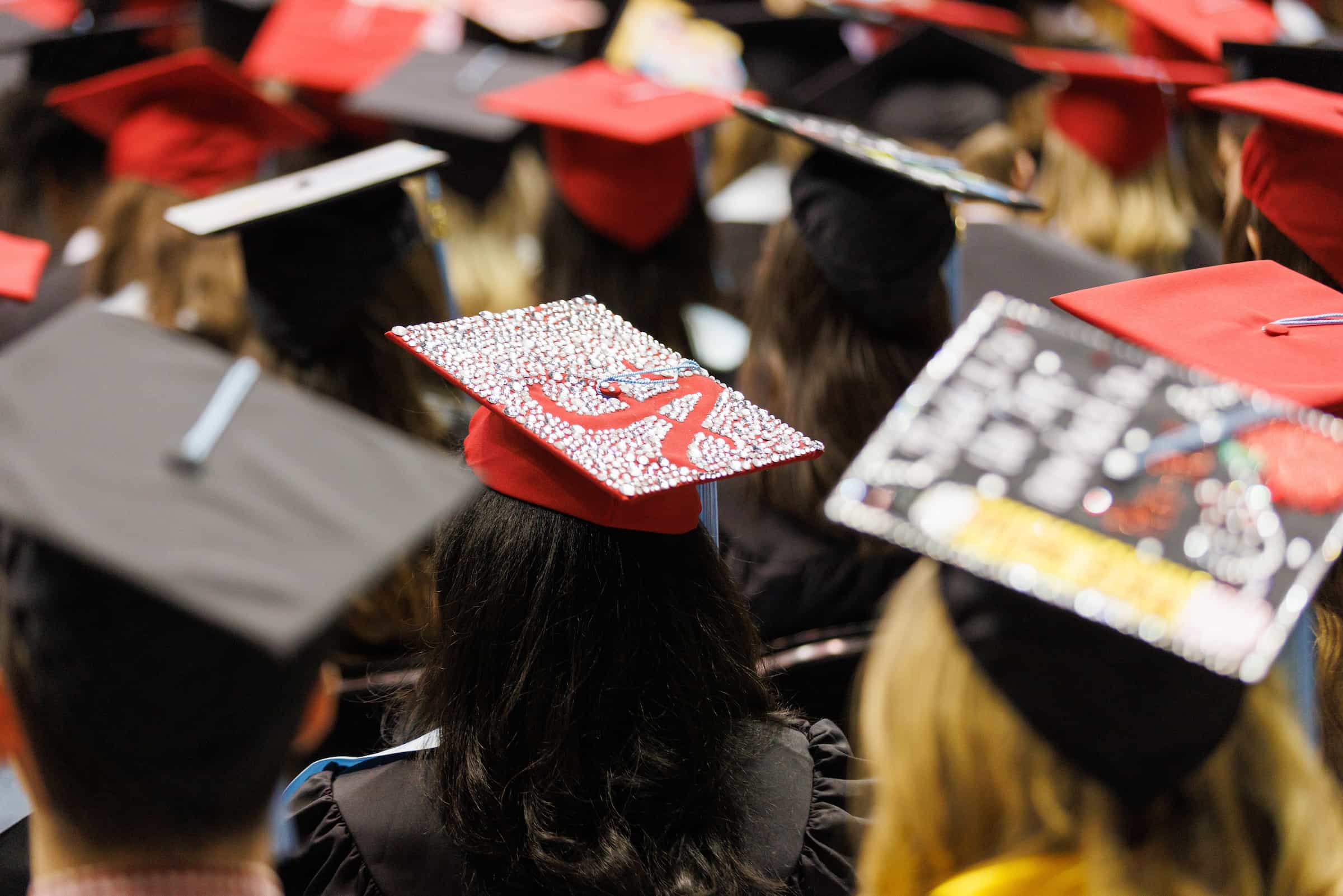Close-up of decorated graduation caps at a graduation ceremony