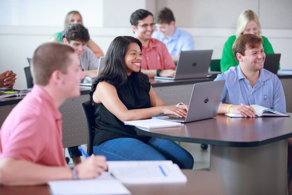 Students smiling while watching a lecture